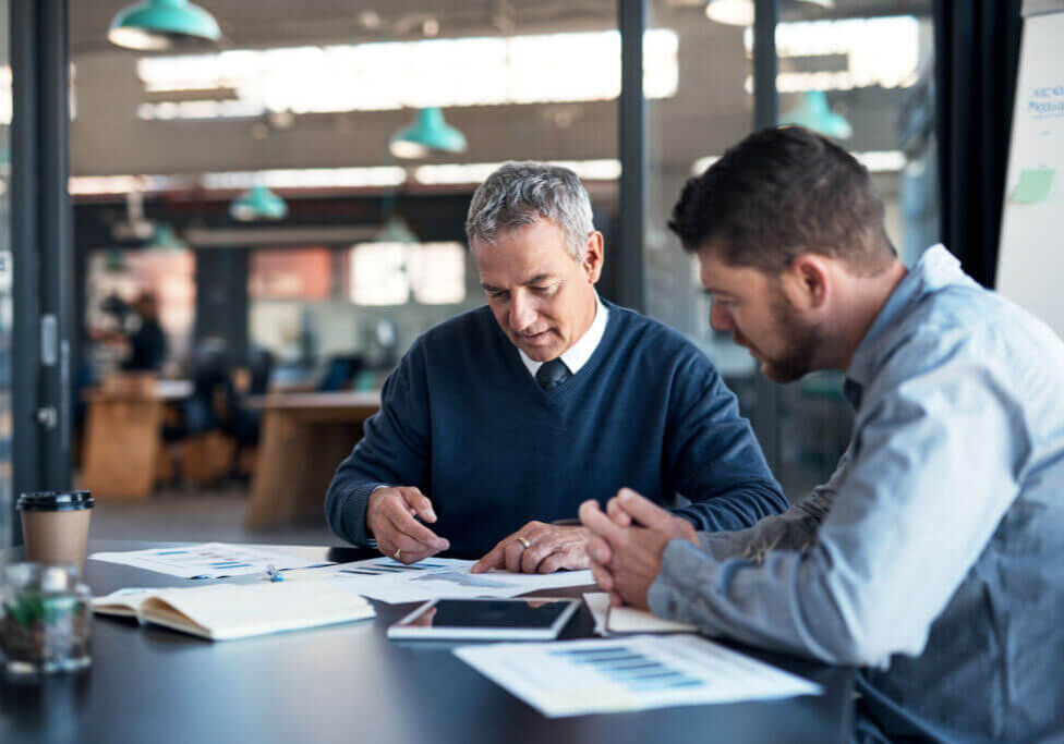 Turning to the stats for some further insights Shot of two businessmen going through paperwork together in an office